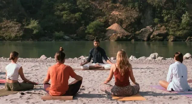 Practising together by a river in the Himalayan foothills